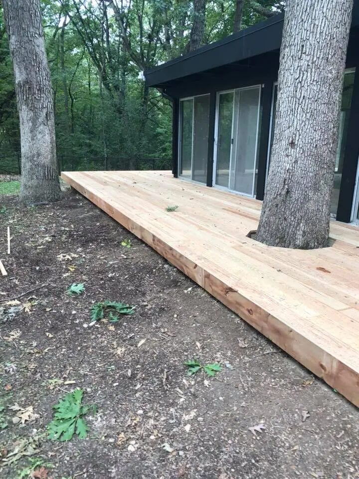 New wood deck carefully built around mature trees