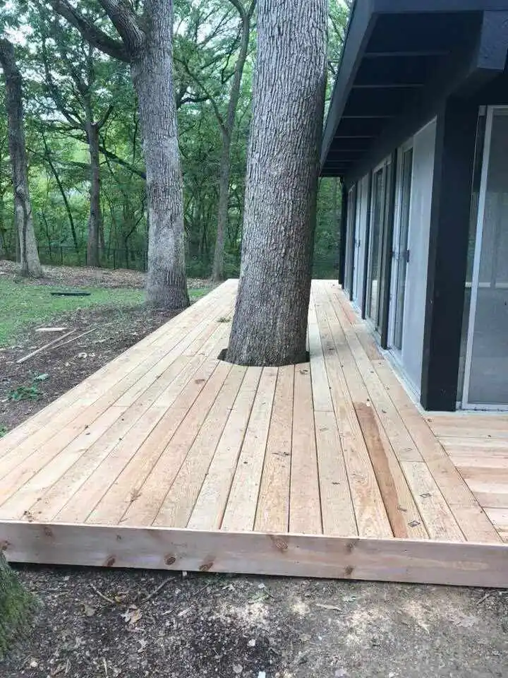 New wood deck platform beside a wooded home
