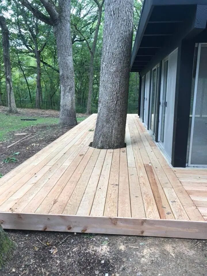 New wood deck platform beside a wooded home
