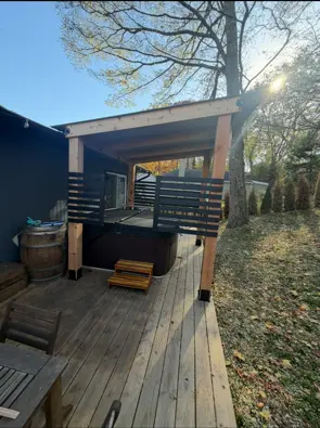 Covered backyard deck with horizontal privacy railing