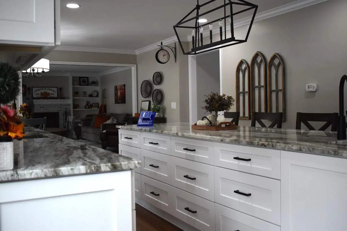 White full-height cabinetry with glass doors and stone counters