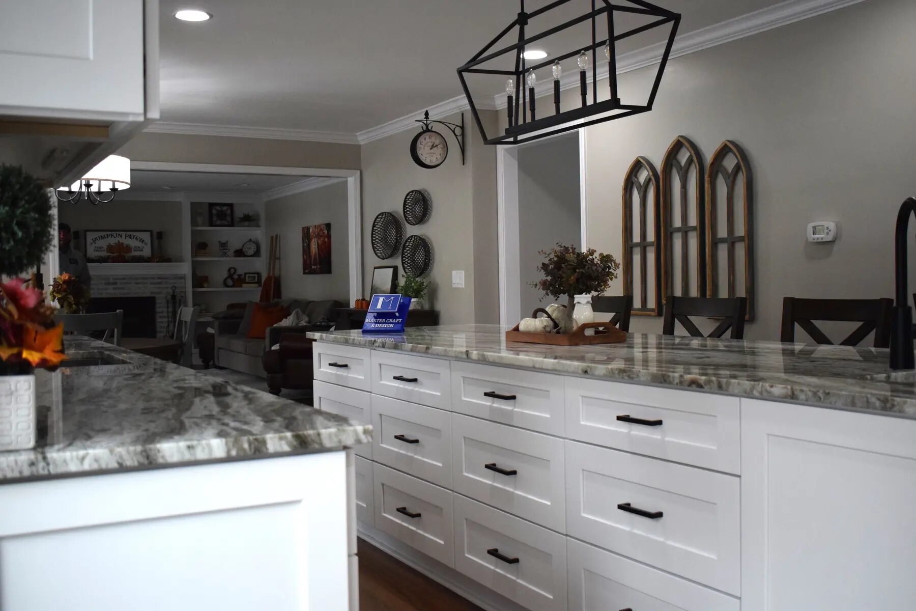 White full-height cabinetry with glass doors and stone counters