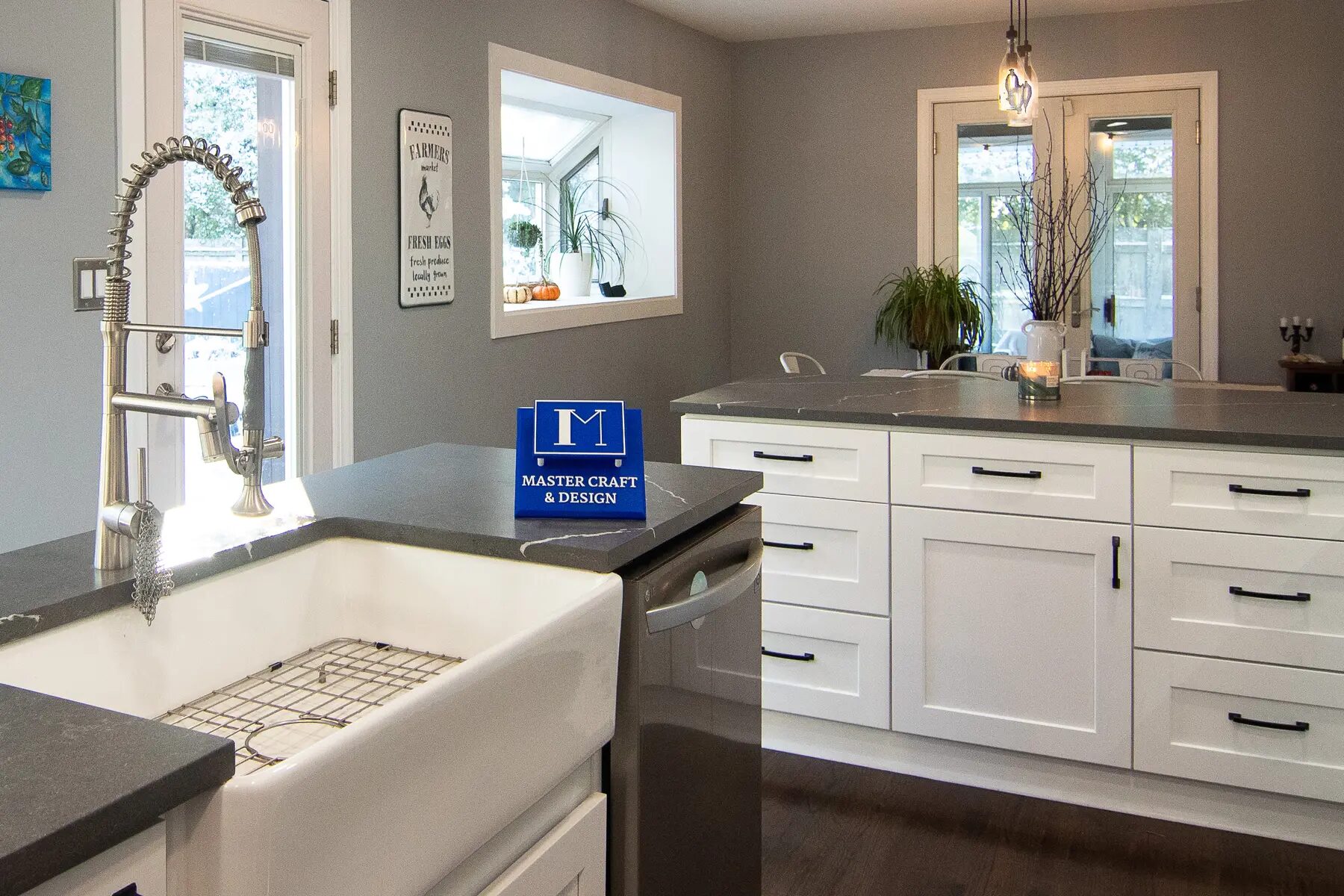 Kitchen cabinetry and counters fitted around a large bright window