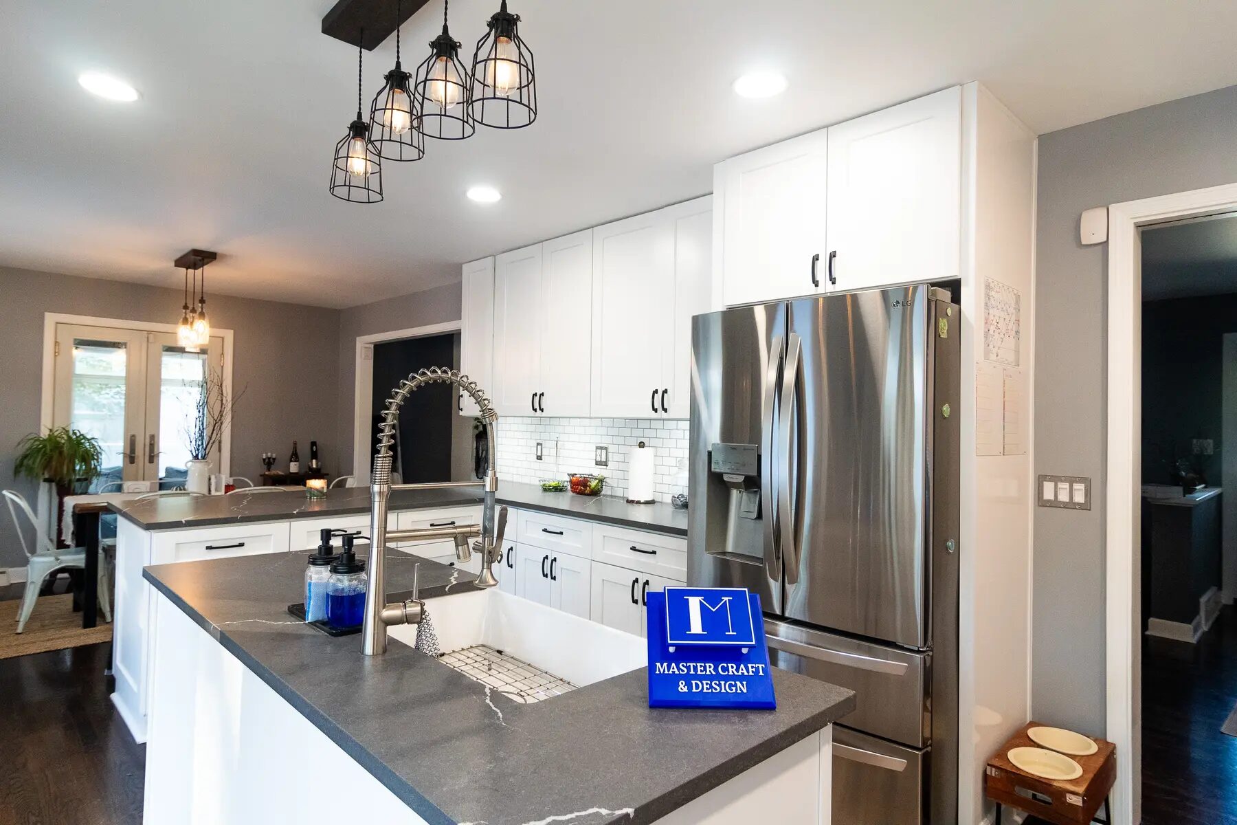 Completed kitchen work zone with stone counters and white cabinetry
